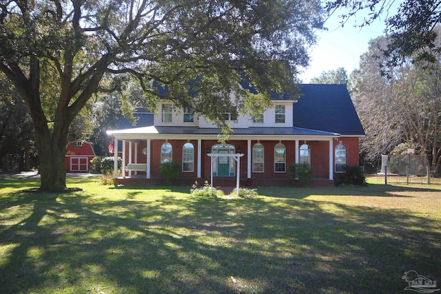 view of front facade with an outbuilding, a front lawn, and a trampoline