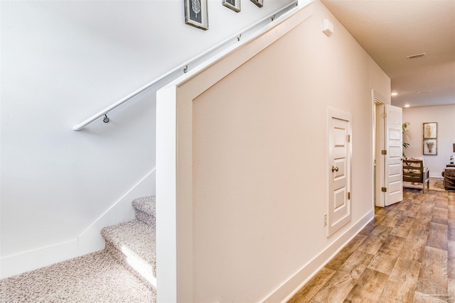 stairs featuring hardwood / wood-style flooring