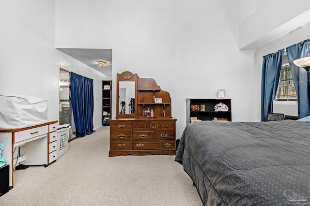 bedroom featuring light carpet and cooling unit