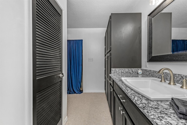 bathroom with vanity and a textured ceiling