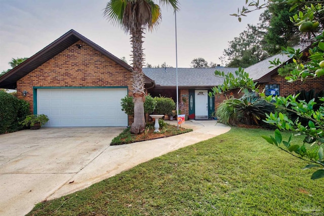 view of front facade featuring a lawn and a garage