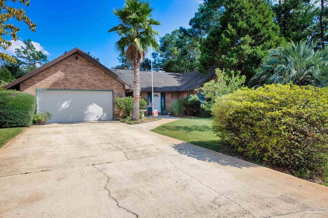 ranch-style home with a front lawn and a garage