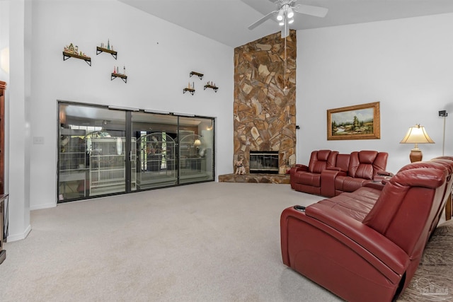 carpeted living room with a stone fireplace, high vaulted ceiling, and ceiling fan