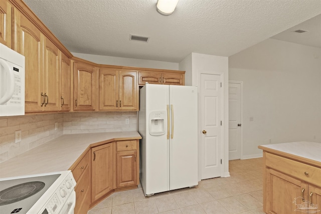 kitchen featuring a textured ceiling, decorative backsplash, light tile patterned flooring, and white appliances