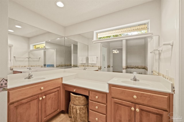 bathroom featuring tile patterned flooring, a textured ceiling, and vanity