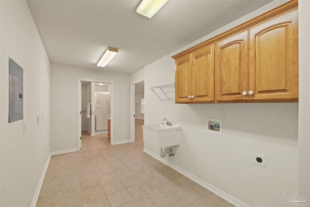 laundry room featuring cabinets, hookup for a washing machine, a textured ceiling, light tile patterned floors, and electric panel