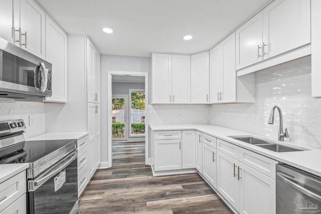 kitchen with white cabinets, dark hardwood / wood-style flooring, sink, and stainless steel appliances