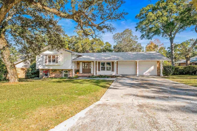 split level home featuring a garage and a front lawn