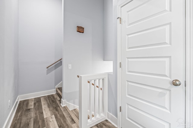 stairs featuring hardwood / wood-style floors