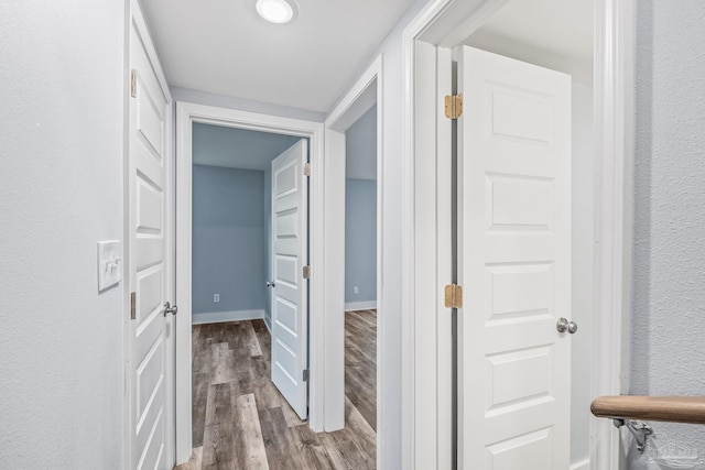 corridor with wood-type flooring