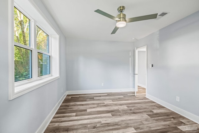 empty room featuring ceiling fan and light wood-type flooring