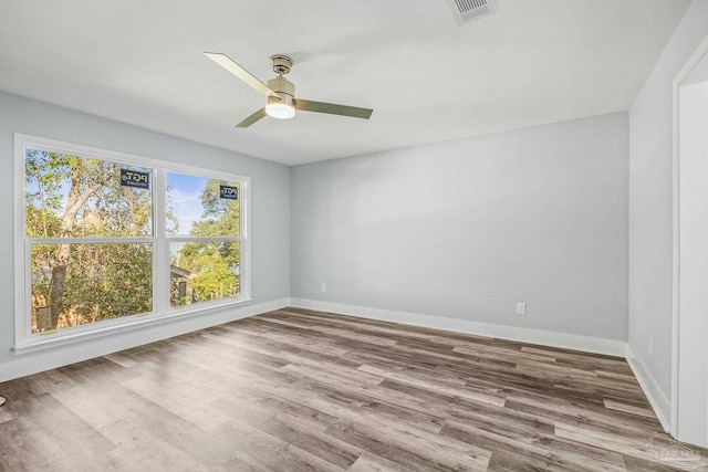 spare room featuring ceiling fan and light hardwood / wood-style flooring