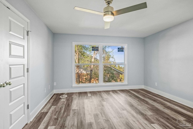 unfurnished room with ceiling fan and hardwood / wood-style flooring