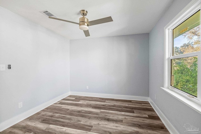 empty room with hardwood / wood-style flooring and ceiling fan