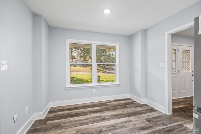 spare room with dark wood-type flooring