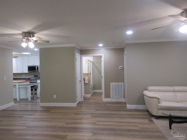 sitting room featuring ceiling fan, dark wood-type flooring, and crown molding