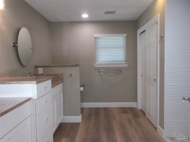 bathroom with vanity and hardwood / wood-style flooring