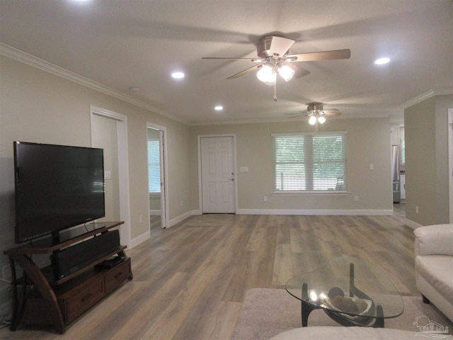 living room with wood-type flooring, ornamental molding, and ceiling fan