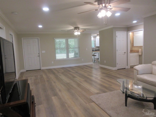 living room featuring ornamental molding, hardwood / wood-style floors, and ceiling fan