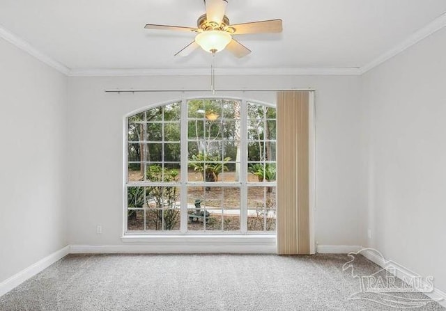 spare room with ornamental molding, carpet floors, ceiling fan, and a healthy amount of sunlight