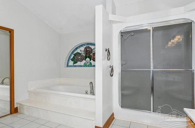 bathroom featuring tile patterned flooring, vanity, and a bathing tub