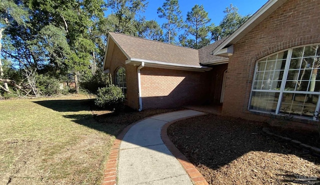 view of property exterior with a yard