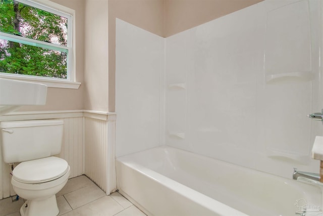 2511 Green Village Rd, Walnut Hill, FL 32568 - bathroom with tile patterned floors, a wainscoted wall, toilet, and washtub / shower combination