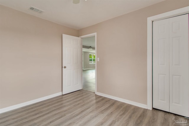 2511 Green Village Rd, Walnut Hill, FL 32568 - unfurnished bedroom featuring light wood finished floors, visible vents, and baseboards