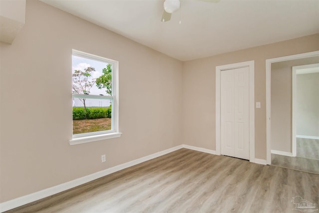2511 Green Village Rd, Walnut Hill, FL 32568 - unfurnished bedroom featuring wood finished floors, baseboards, a closet, and ceiling fan