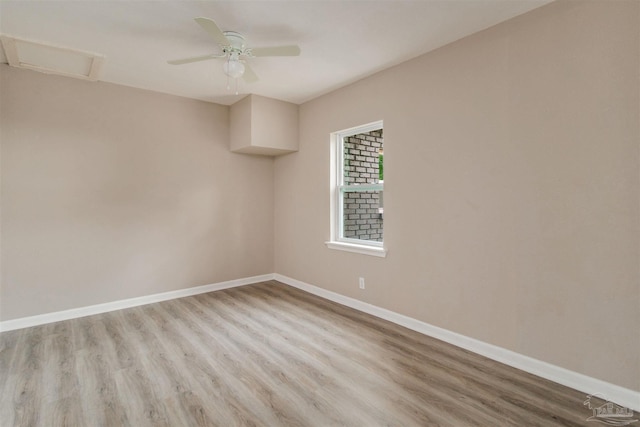 2511 Green Village Rd, Walnut Hill, FL 32568 - unfurnished room featuring attic access, light wood-style floors, and baseboards