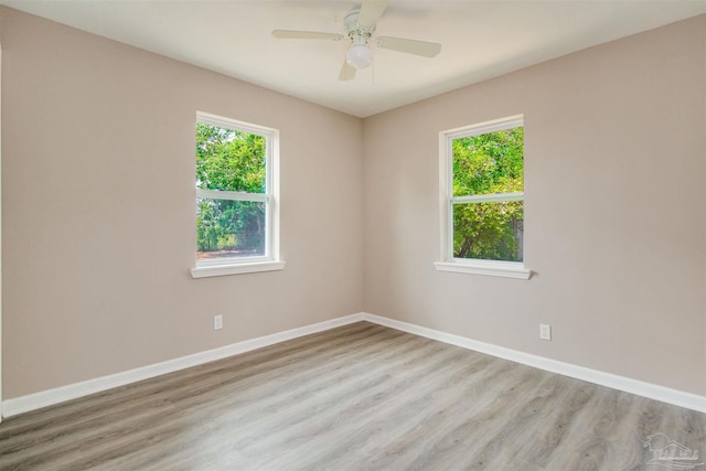 2511 Green Village Rd, Walnut Hill, FL 32568 - empty room with baseboards, wood finished floors, and a ceiling fan