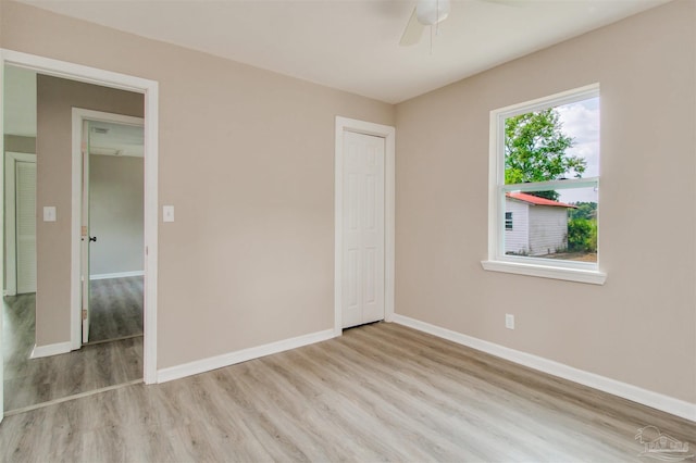 2511 Green Village Rd, Walnut Hill, FL 32568 - unfurnished bedroom with ceiling fan, a closet, baseboards, and wood finished floors