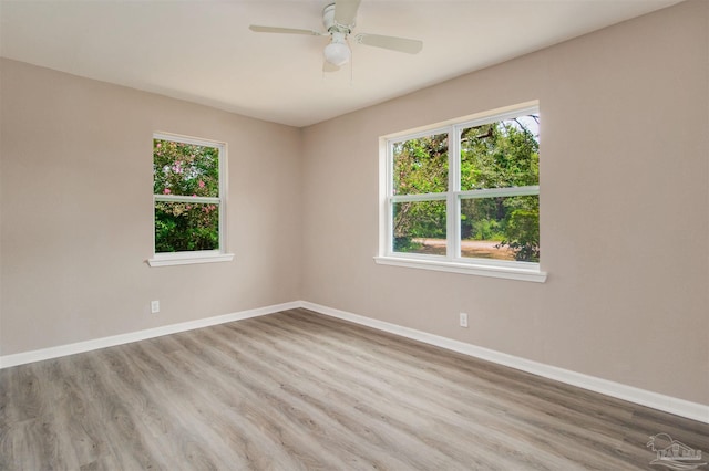 2511 Green Village Rd, Walnut Hill, FL 32568 - unfurnished room with baseboards, wood finished floors, and a ceiling fan