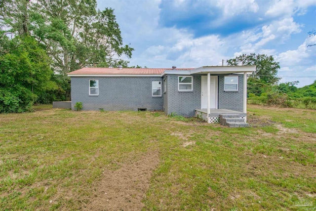 2511 Green Village Rd, Walnut Hill, FL 32568 - back of house with a lawn and brick siding