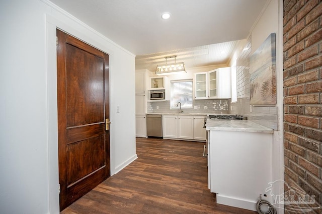 kitchen with white cabinetry, decorative light fixtures, stainless steel appliances, dark wood-type flooring, and decorative backsplash