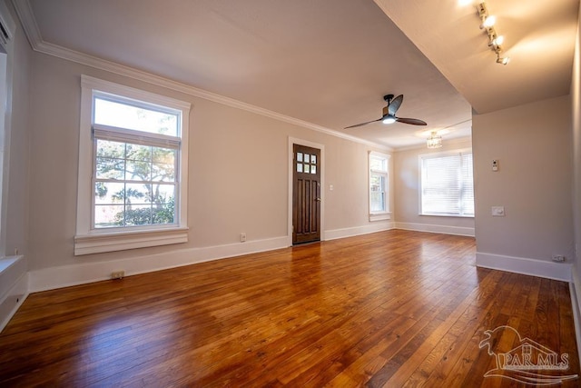 unfurnished living room with wood-type flooring, ceiling fan, crown molding, and rail lighting