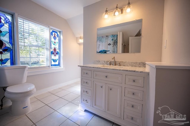 bathroom with vanity, tile patterned flooring, toilet, and lofted ceiling