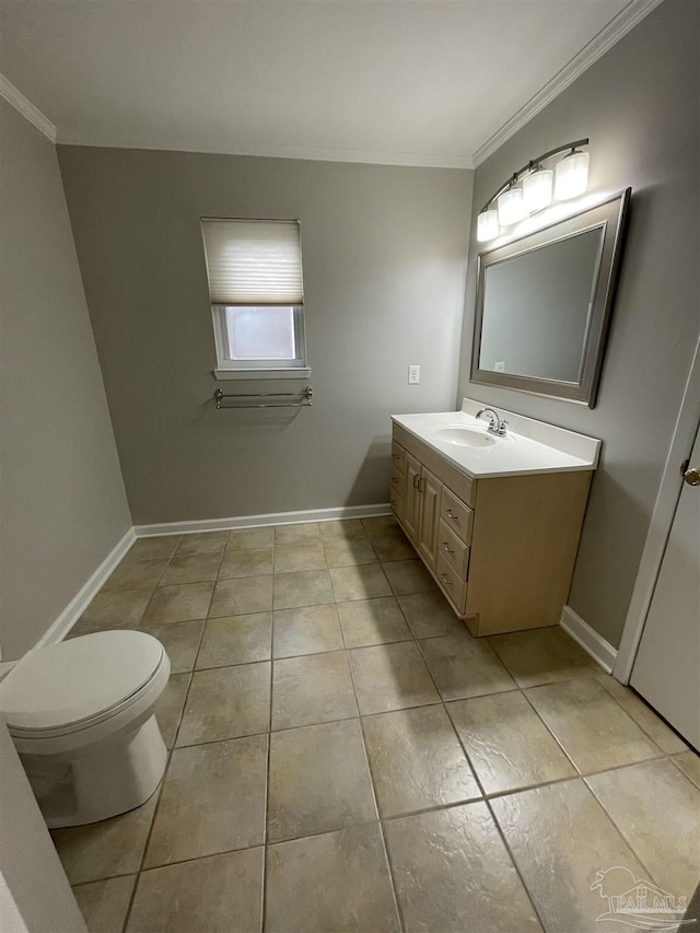 bathroom featuring crown molding, tile patterned floors, vanity, toilet, and baseboards