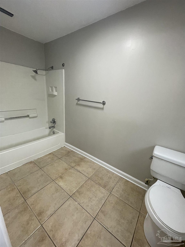 bathroom featuring tile patterned flooring, toilet, shower / washtub combination, and baseboards