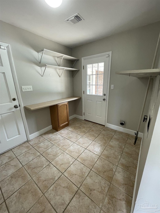 laundry area featuring an office area, light tile patterned flooring, baseboards, and electric dryer hookup