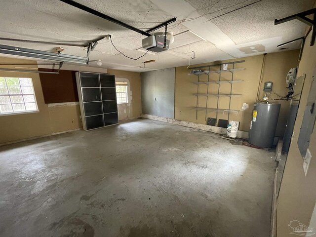 garage featuring a garage door opener and electric water heater