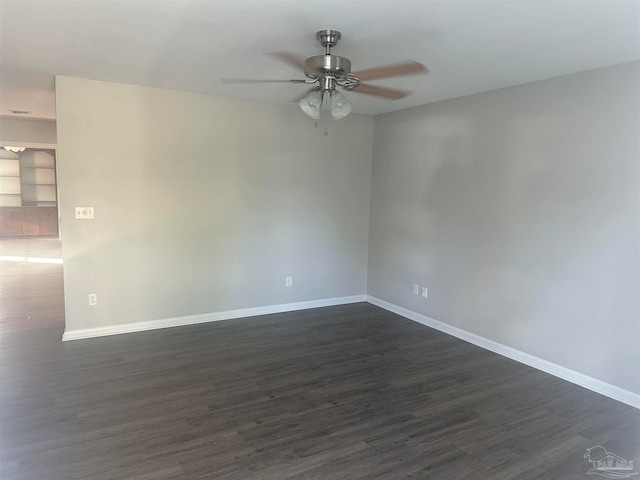 unfurnished room with ceiling fan and dark hardwood / wood-style flooring