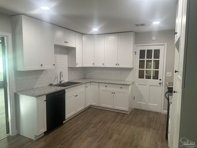 kitchen with decorative backsplash, white cabinets, sink, dark hardwood / wood-style flooring, and black dishwasher