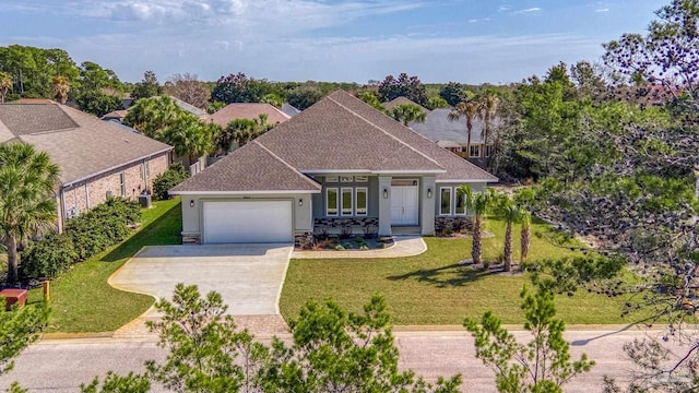 view of front of property with a garage and a front yard