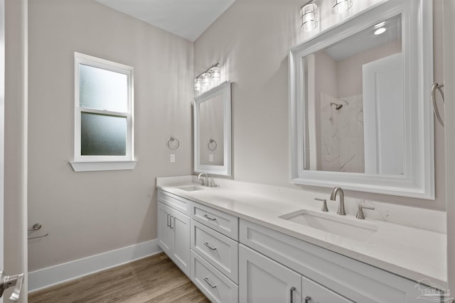 bathroom featuring vanity, hardwood / wood-style floors, and walk in shower