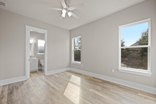 unfurnished bedroom with light hardwood / wood-style flooring, ceiling fan, and ensuite bathroom