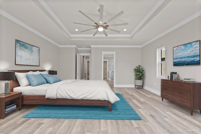 bedroom featuring a raised ceiling, crown molding, and light wood-type flooring