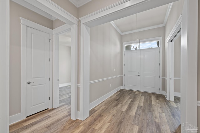 foyer entrance featuring hardwood / wood-style flooring and ornamental molding