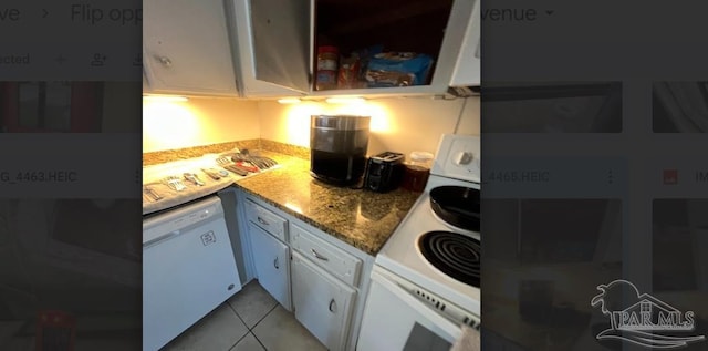 kitchen featuring stone counters, white cabinetry, white appliances, and light tile patterned floors