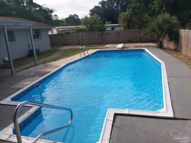 view of swimming pool featuring central AC unit